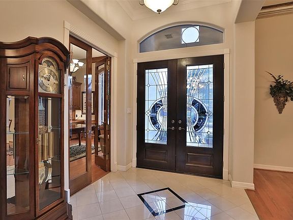 STUNNING AND IMPRESSIVE FOYER - This beautiful home has glowing marble floors in the entry with "blue eyes" granite inserts.