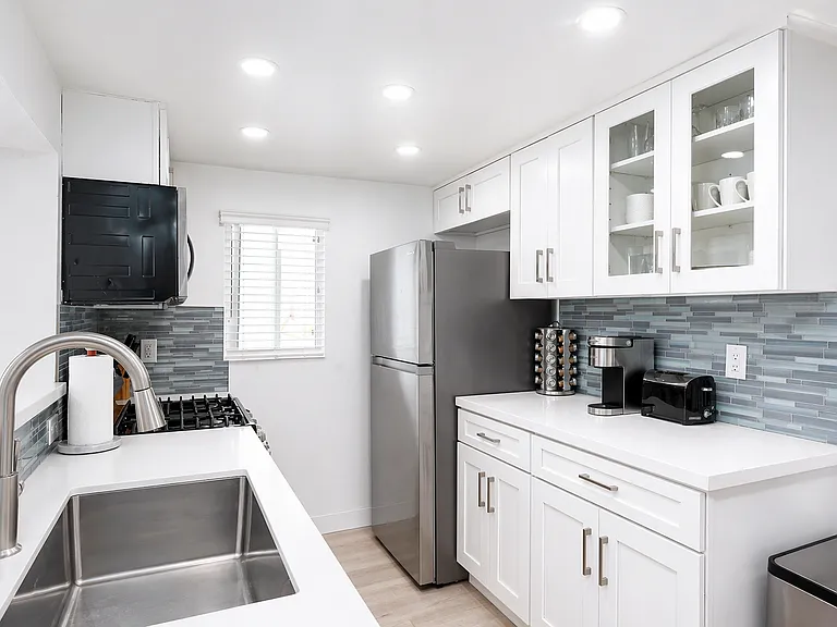 Modern kitchen with stainless steel appliances and storage