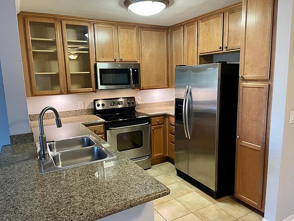 kitchen with stainless steel appliances. New vinyl flooring in progress throughout.