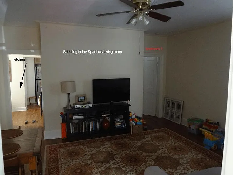 this is the living room, looking into the kitchen on the left and the 2nd bedroom/office on the right
