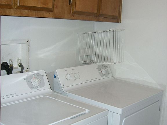 Landry room fits a full size washer and dryer plus extra storage!
