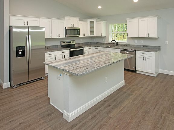 Granite couters , soft close cabinets , high end appliances, and recessed lighting .