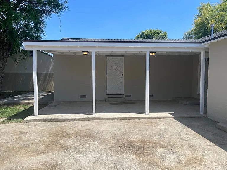 Covered patio great for entertaining with access from both main bedroom and den.