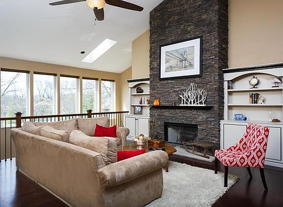 Breathtaking floor to ceiling stone fireplace in Vaulted Great room overlooking atrium & professiona