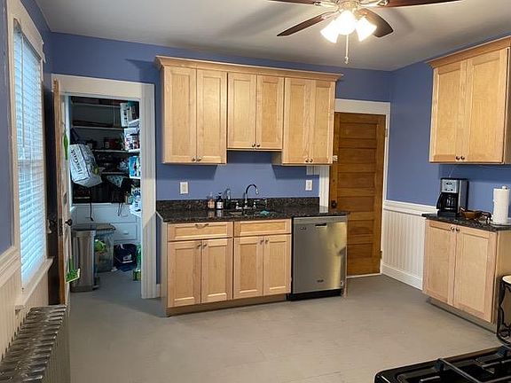 Modern kitchen with pantry, new tile floor, granite countertops and cabinets