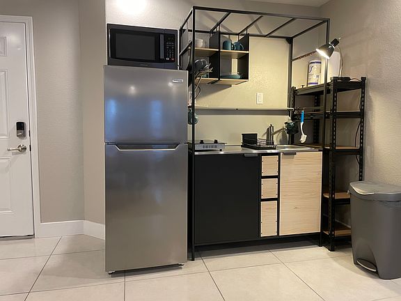 Kitchenette is modern w/ sink, garbage disposal, two burner cooktop, coffee maker, blender, microwave, fridge, plates, cups, and utensils included.