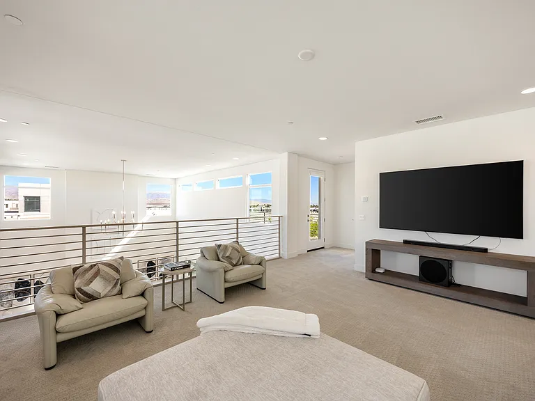 This media room is located upstairs and overlooks the great room and dining area!