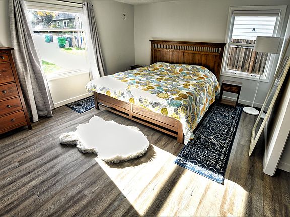 Primary bedroom with windows on 3 walls, large closet