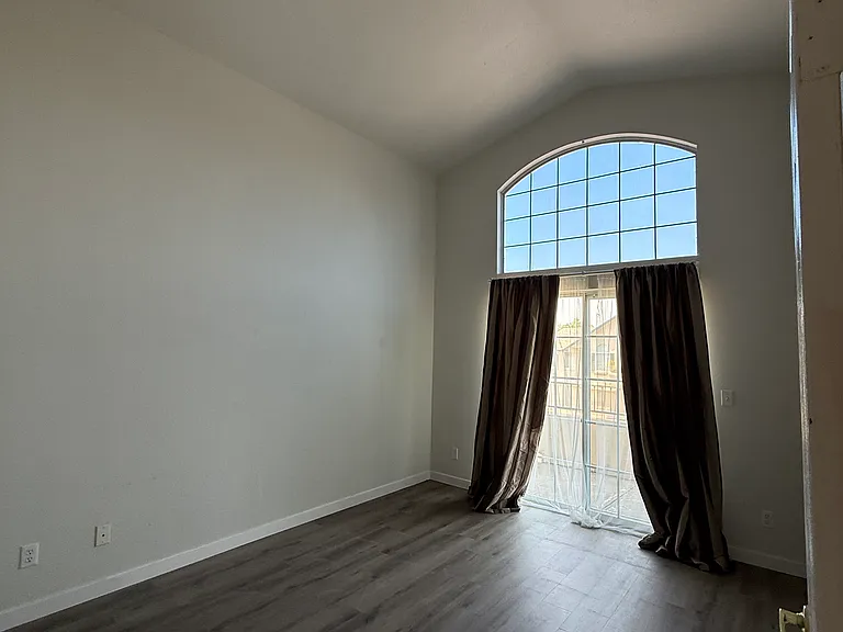 Master bedroom with a balcony.