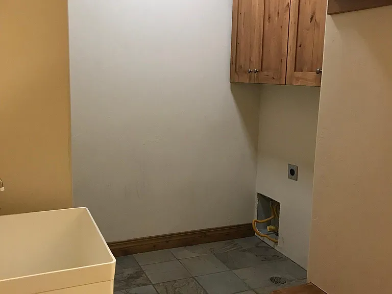 Main Floor Laundry with Sink and Storage