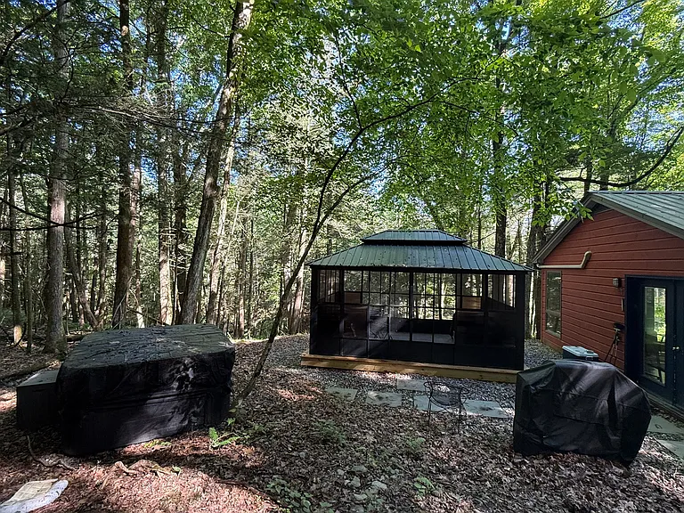 Hot tub on left, screened porth, grill on right.