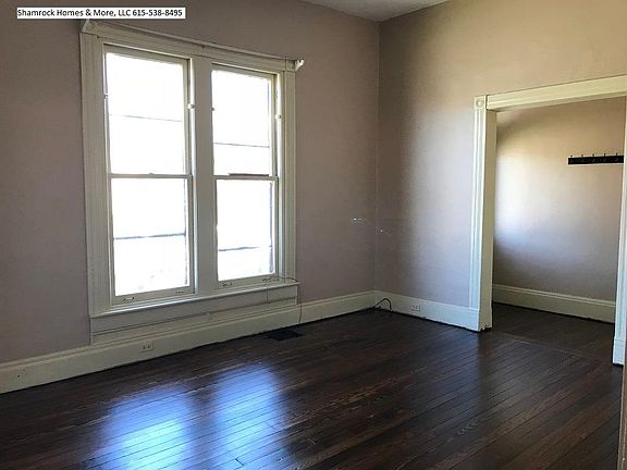 LIving room high ceilings, hardwood floors, large windows