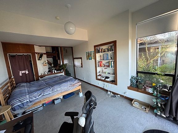 Light and airy main room, big enough for desk and bed.