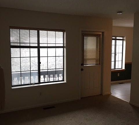 living room looking out to deck and kitchen