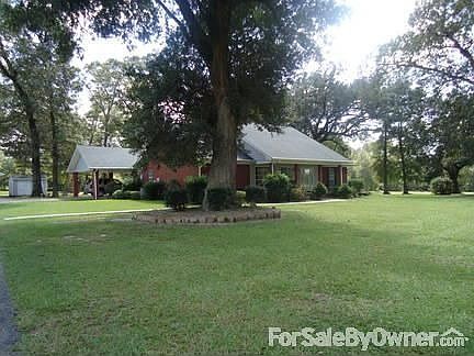 Front View of home among Beautiful Oaks