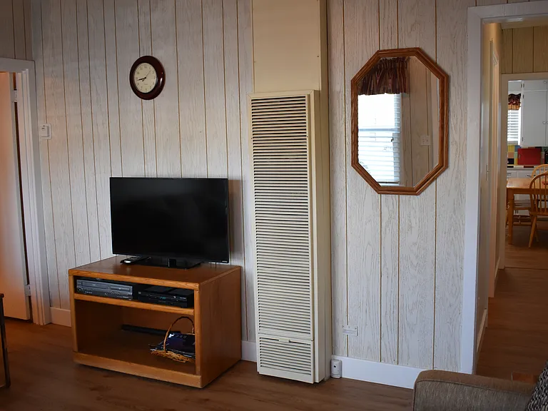 Living room with Smart TV and hall to the rest of the home