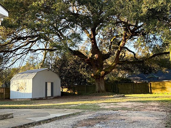 Fenced-in backyard with 12x20 storage