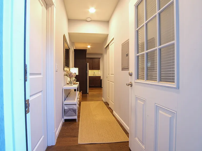 Entrance with view through foyer into kitchen