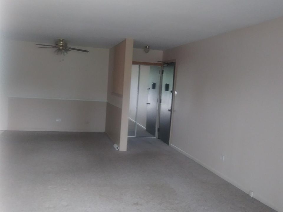 View from the balcony/deck to the front door, across the living/dining room
