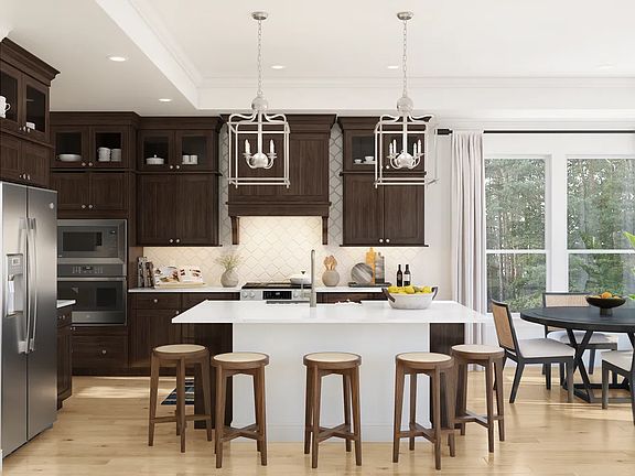Kitchen with upper glass cabinets and pendant lighting