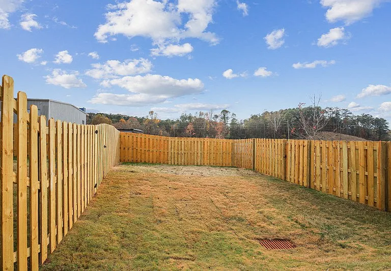Another view of the fenced in backyard.