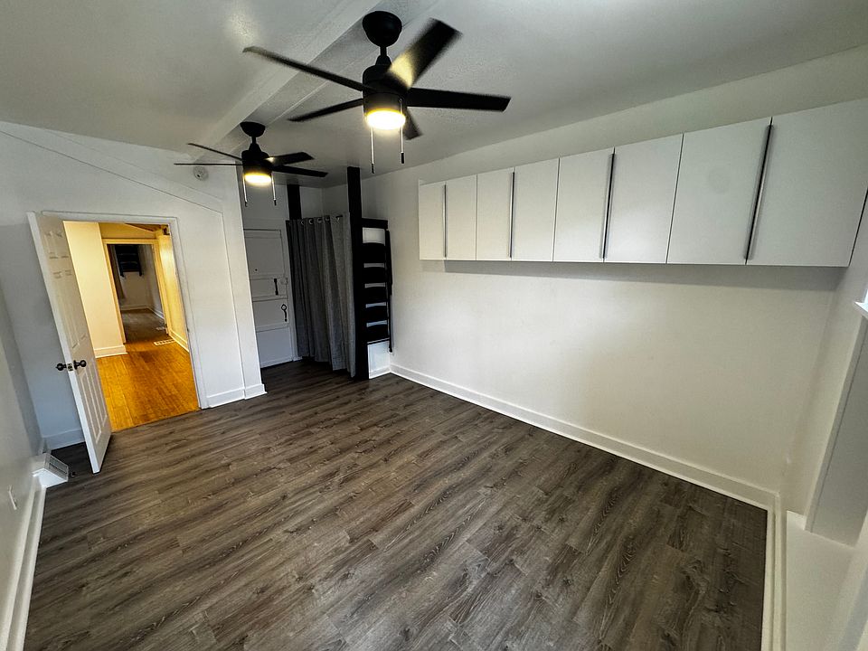 Back bedroom with ceiling fans, plenty of closet and storage space.