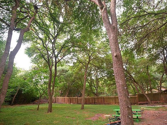 Backyard is shaded, too. Your large backyard borders on green belt creek. Sit down for a backyard picknic or grill in your fire place.