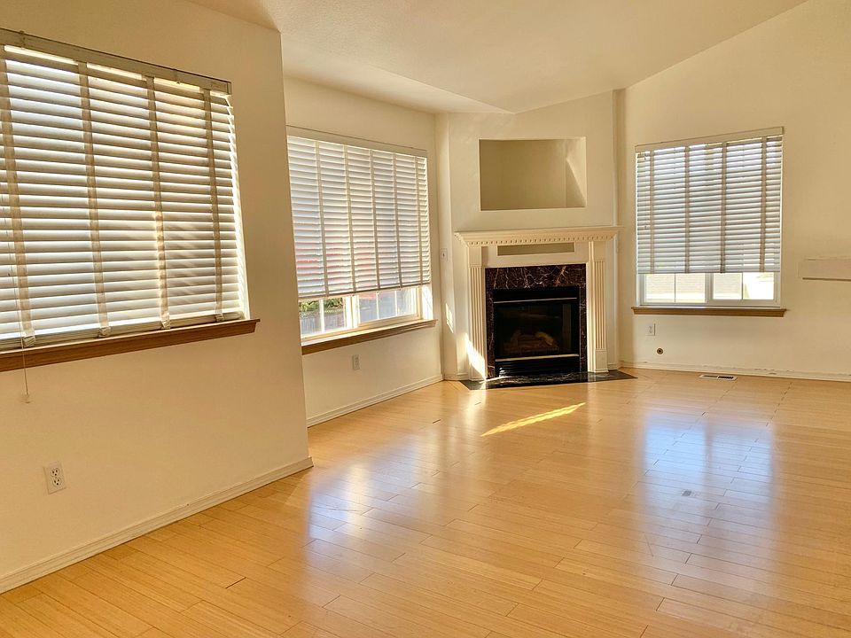 Open and bright living and dining room with a beautiful fireplace