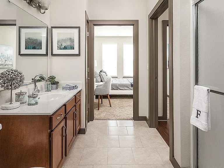 Designed with flow in mind_your oversized vanity and spa-style shower connect seamlessly to the bedroom.