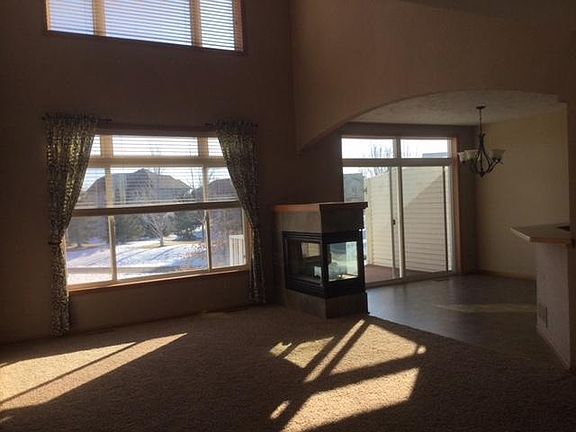 Living Room / Fireplace / Dining Area with Deck