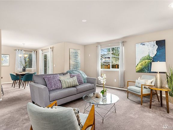 Living room opens into dining room, perfect for gatherings.
