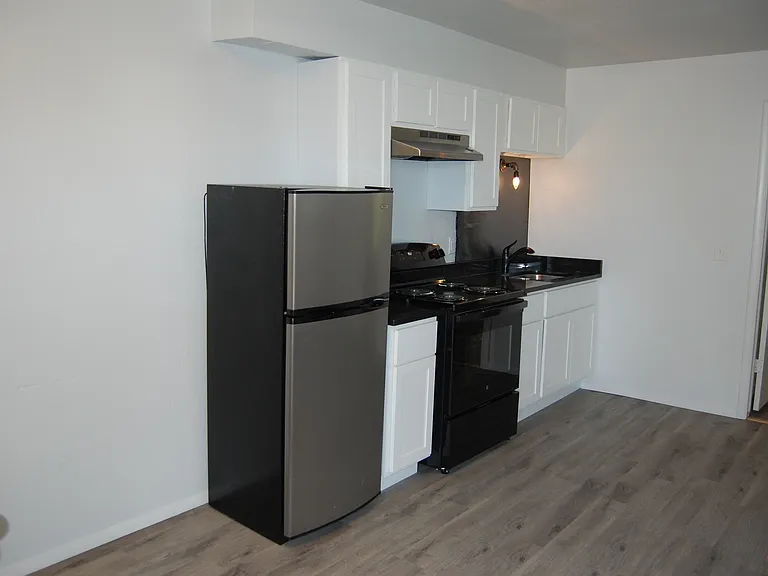 Kitchen has new black electric stove.