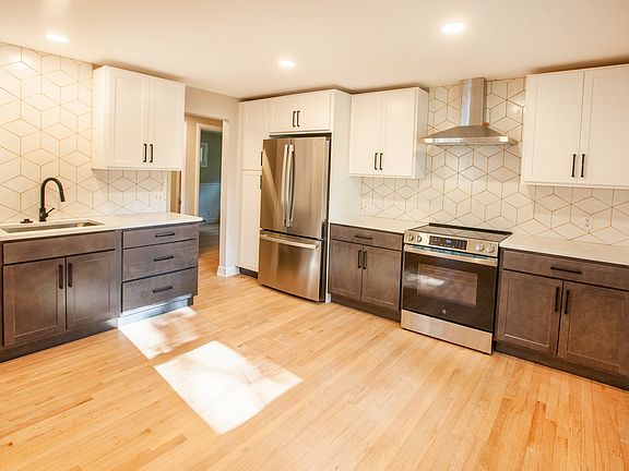 Fully remodeled kitchen with quartz counters and tile backsplash