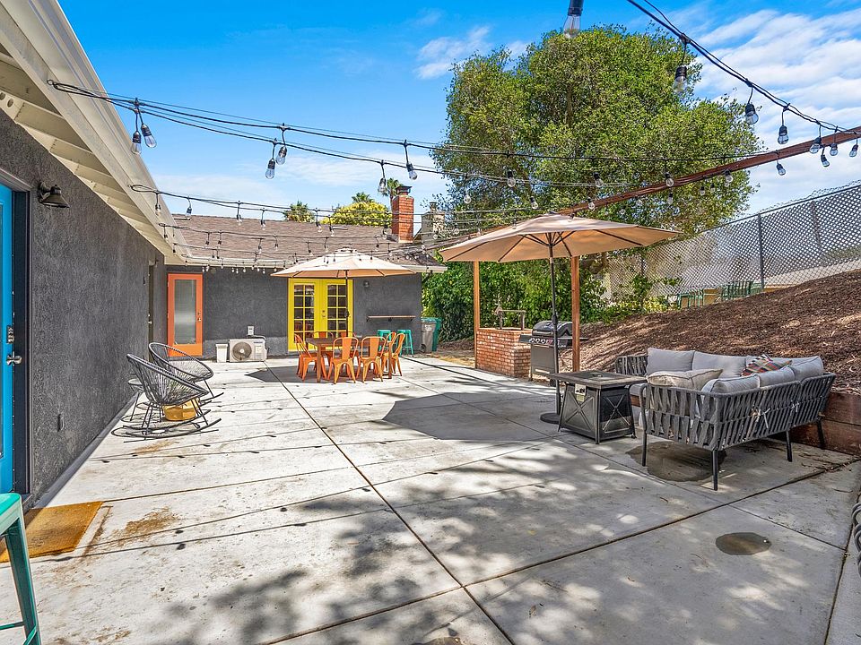 Shared backyard. Blue door to the 3 bedroom house. Yellow door is the backdoor to the 4 bedroom house.