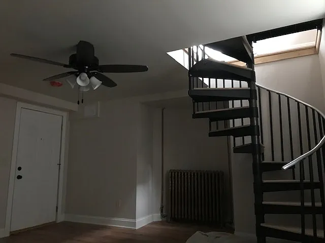 Shows Bedroom door to lower level common area which includes laundry, storage, and exterior exit.
