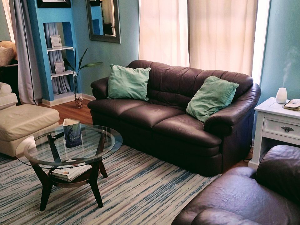 Overstuffed couches, carpet over hardwood floors, freshly painted, central air, smart TV