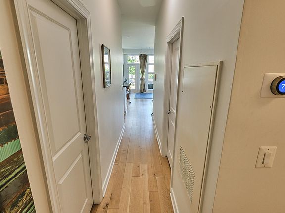 Hallway to living room. Second bedroom is on the right, second bathroom is on the left.