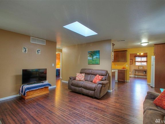 Flowing living room to kitchen with eating space and formal dining room.