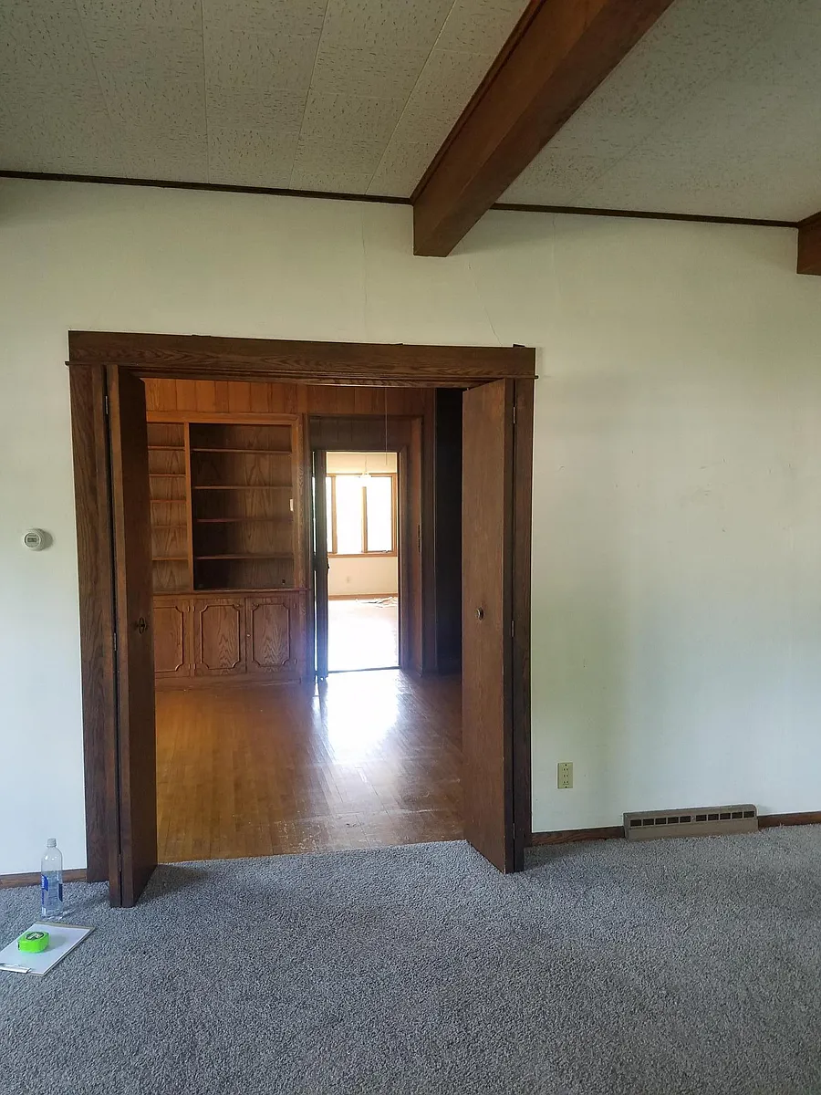 Looking through double doors from living room to library room to kitchen - 1500 Clearwater Rd