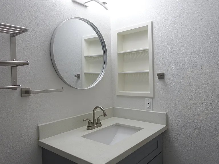 Bathroom #1: Recessed shelving. Satin nickel fixtures
