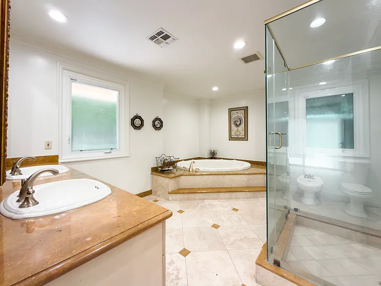Spa-style primary bathroom with a soaking tub and glass shower brings luxury to this Beverly Hills luxury rental at 1094 Garden Lane, a 90210 home for rent.