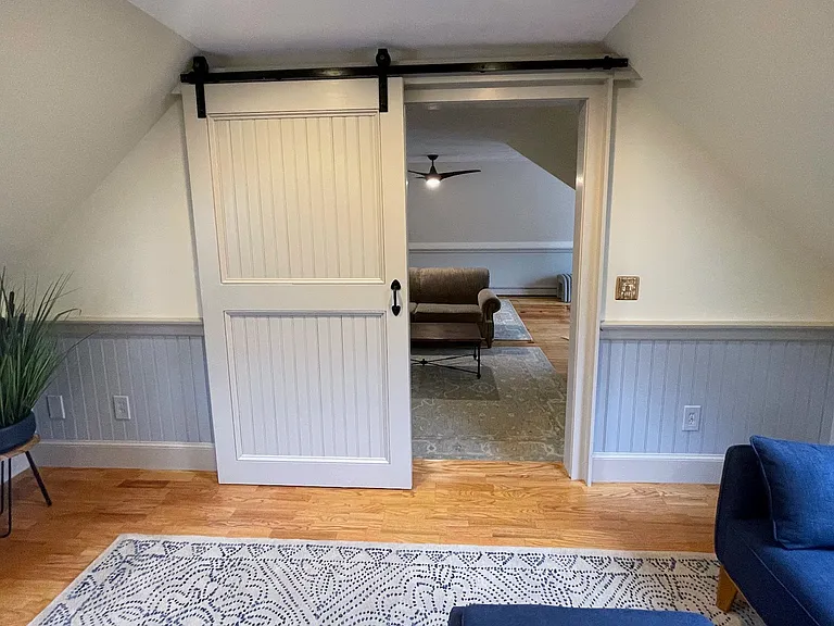view from Kitchen into the seating and step down into living room, office and separate sleeping area
