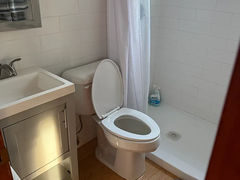 bathroom with shower- (ample shelving for storage not pictured here)