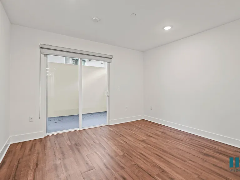 Bedroom with Vinyl Flooring, Recessed Lighting, and Patio Area