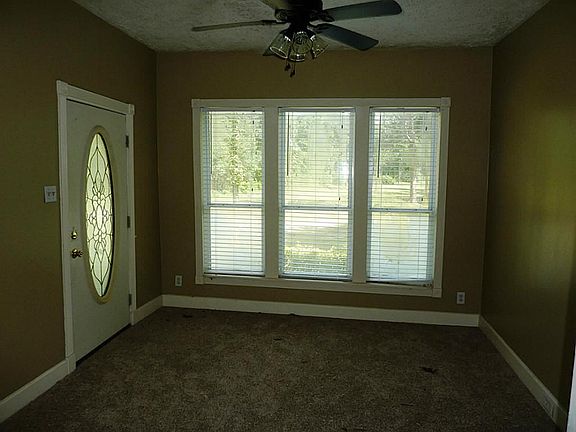 Front reception/living room - carpeted flooring and lighted ceiling fan
