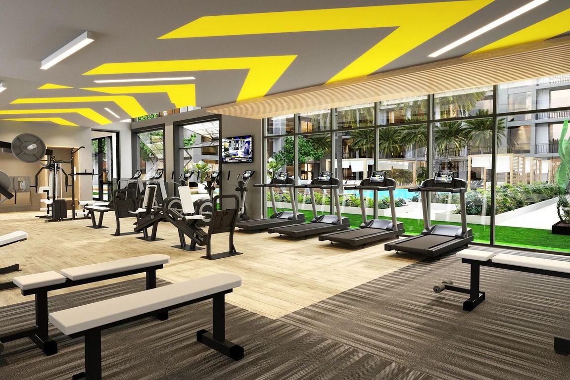 Club-quality fitness studio with spin bikes, sauna, and activity lawn.