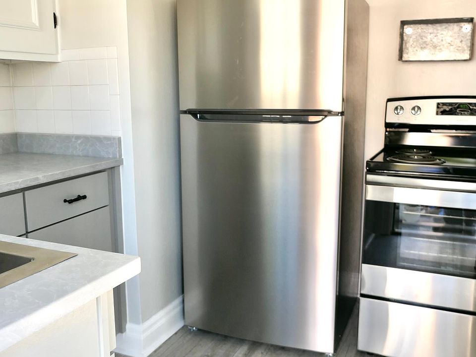 Kitchen with new stainless steel fridge & stove, new flooring, cabinetry and countertops