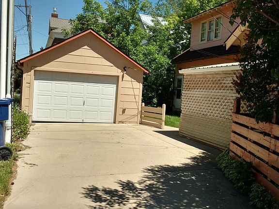 In the back is a garage and back entry to the main level, basement, and a side staircase to the upstairs apartment. 