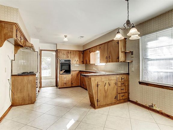 Kitchen area with tile counter tops.
