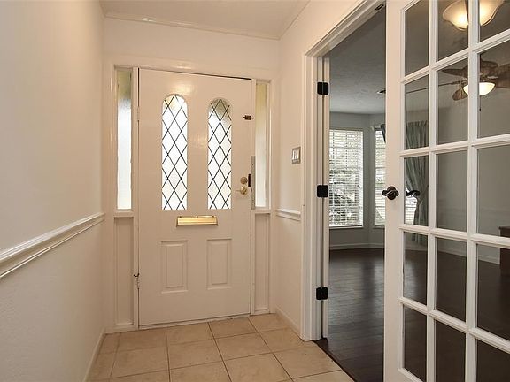 Tile flooring welcomes you into the home with the Study to the left through the double french doors.